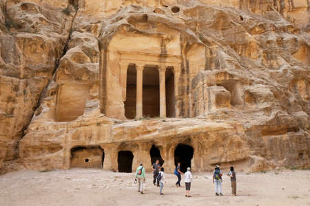 Little Petra (Siq al-Barid), Jordan - circa May 2022: Silhouettes of tourist next to temple in ancient town Little Petraのeditorial素材