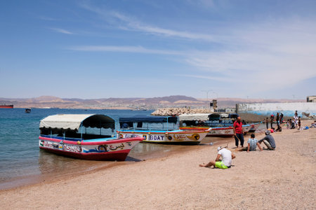 Aqaba, Jordan - circa June 2022: Beach with local boats on the Red Sea in Aqaba, Jordanのeditorial素材