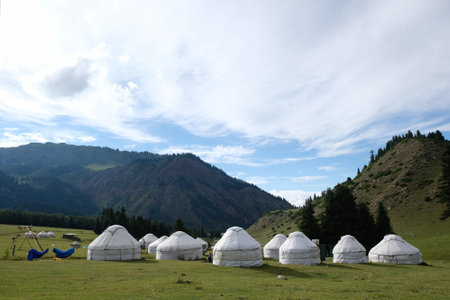 Yurt camp in Karakol Mountains, Tien Shan Mountains, Kyrgyzstan, Central Asia. Traditional nomad's yurts on green mountain meadow in summer.の写真素材