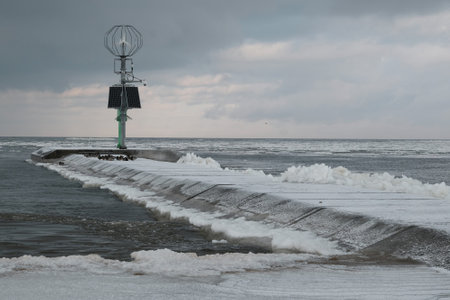 Frozen concrete wharf with navigation point by estuary of Vistula river, Sobieszewska Island, Polandの写真素材