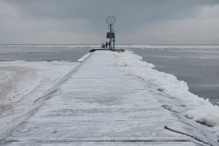 Frozen concrete wharf with navigation point by estuary of Vistula river, Sobieszewska Island, Polandの写真素材