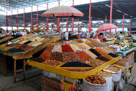BISHKEK, KYRGYZSTAN - circa July 2021: Stands with dried fruits in Osh Bazaar, central market in Bishkek, Kyrgyzstan.のeditorial素材