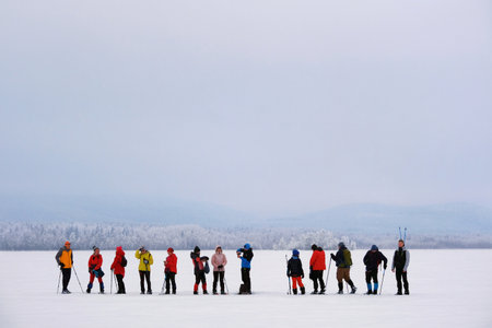 Boden, Sweden - circa Februrary 2023: A group of snowshoe tourists walks in the lake in Boden just before the Arctic Circle, Swedenのeditorial素材