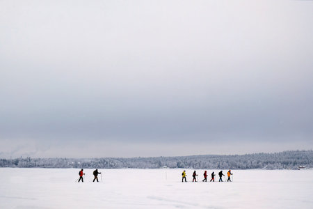 A group of snowshoe tourists walks in the lake in Boden just before the Arctic Circle, Swedenの写真素材