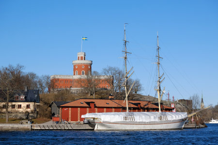 Stockholm, Sweden - circa February 2023: The beautiful historical Kastellet citadel on the islet Kastellholmen and sailing ship standing by the shore in central Stockholm, Swedenのeditorial素材