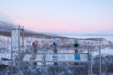 Abisko, Sweden - circa February 2023: Abisko Ostra viewpoint with information board. Snowy scenery of mountains and lake Tornetrask. Abisko National Park, Arctic Circle, Swedish Lのeditorial素材