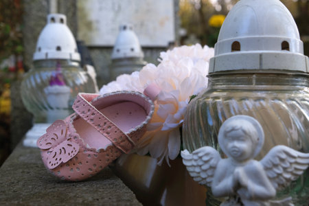 A pink shoe on a child's grave in the cemetery.