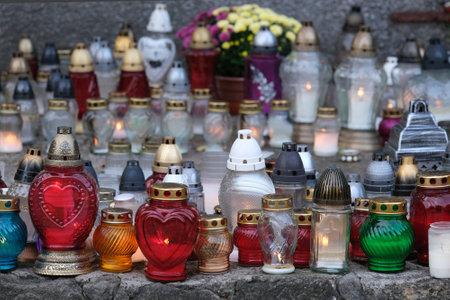 A lot of colorful lit candles standing at the memorial site