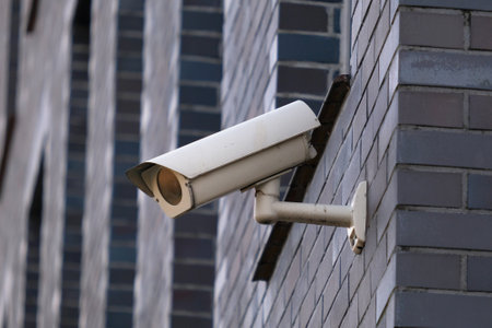A close-up of a camera mounted on the wall of a building