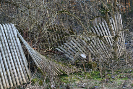 Destroyed fallen wooden fence in the countrysideの写真素材