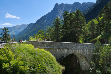 Pyrenees National Park, France - July 8, 2024: Stone bridge over river around Hotel Pont d'Espagne on trail from Cauterets to lake Lac de Gaube. Pyrenees National Park, Franceのeditorial素材