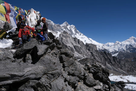 Himalayas, Nepal - October 30, 2024: Kongma La Pass 5535 m with silhouettes of trekkers. Amazing views on trekking from Dingboche through the pass. Everest Base Camp trek. Himalayasのeditorial素材