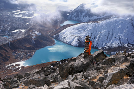 Amazing mountain panorama of turquoise lake and buildings of Gokio settlement from peak Gokyo Ri. It is famous region of Himalayas, Nepalの写真素材