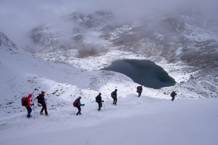 Winter mountain panorama with climbing trekkers during route to Renjo La Pass. Sagarmatha National Park, Himalayas, Nepalの写真素材