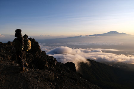 View of Kilimanjaro at sunrise while trekking Mount Meru, a volcano in Tanzania. Silhouette of...