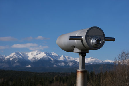 Viewpoint Pass over Lapszanka with snow-capped peaks of High Tatras and Bialskie Tatras mountains and blurred binoculars in foreground, Polandの写真素材