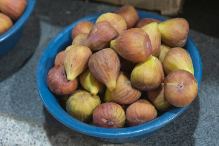 Close up of fresh figs in blue bowl at stall in bazaar in Dushanbe, Tajikistan