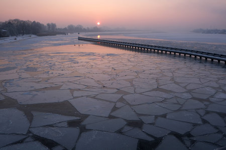 Amazing scenery of frozen Vistula river with shuga - ice floe in shape of discs. An interesting phenomenon on Vistula river. The estuary of Vistula, Sobieszewska Island, Polandの写真素材
