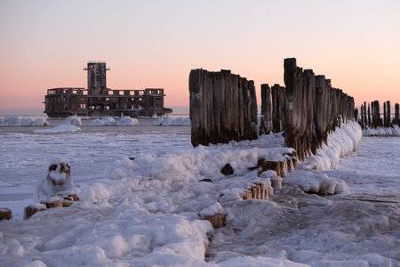 Frozen Baltic Sea beach with wooden poles in Babie DoÅy on a beautiful winter day, Gdynia. Polandの写真素材