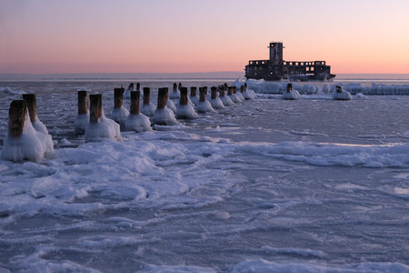 Frozen Baltic Sea beach with World War II torpedo platform and wooden poles in Babie DoÅy on a beautiful winter day, Gdynia. Polandの写真素材