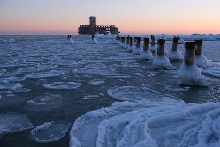 Frozen Baltic Sea beach with wooden poles in Babie DoÅy on a beautiful winter day, Gdynia. Polandの写真素材