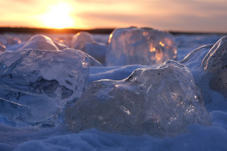 Amazing scenery of block of ice on beach of Baltic Sea in Sobieszewska Island in sunset light....