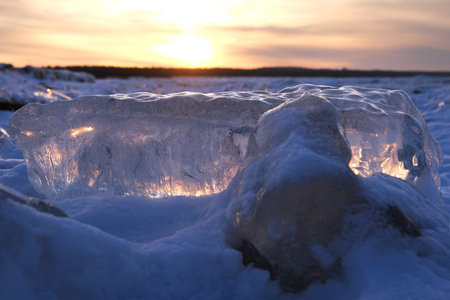 Amazing scenery of block of ice on beach of Baltic Sea in Sobieszewska Island in sunset light....