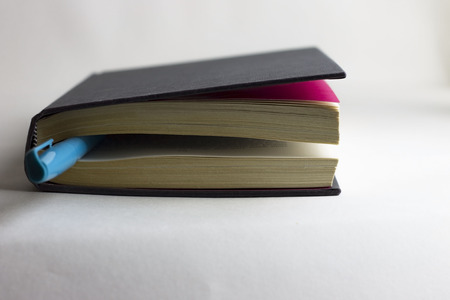 Book and a pen on white backgroundの写真素材