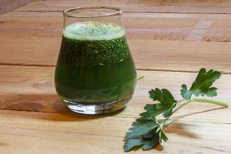 Fresh green juice with parsley on wooden backgroundの写真素材