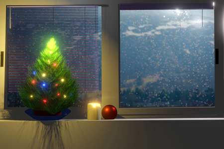 Christmas tree in front of the window and falling snow outsideの写真素材