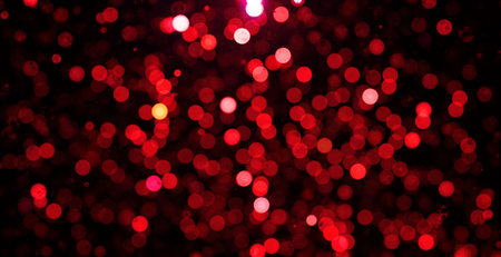 Red bokeh background. Shining glowing defocused Christmas lights. Valentine's Day background.の写真素材