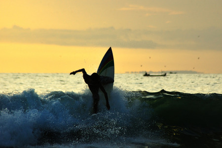 action surfing with nice sunsetの写真素材
