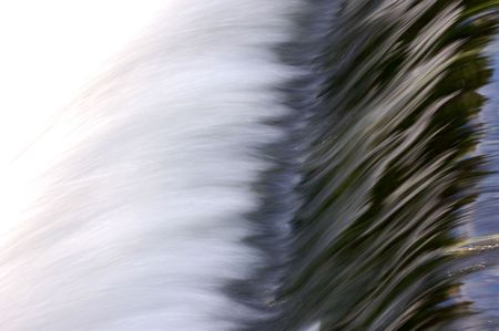 Water flowing over weir, taken  with slow shutter speed - horizontal compositionの写真素材
