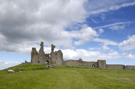 The ruined front of Dunstanburgh Castle, Northumberlandの写真素材
