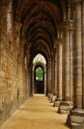 Arches and columns of an ancient Abbeyの写真素材