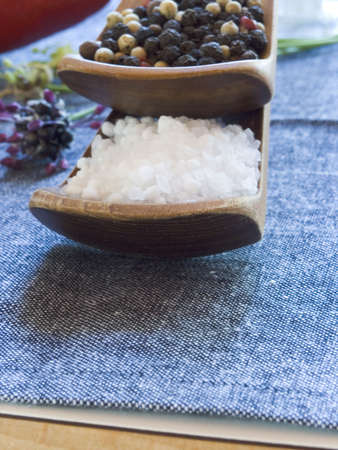 salt and pepper on old woods spoon (dark background)の写真素材