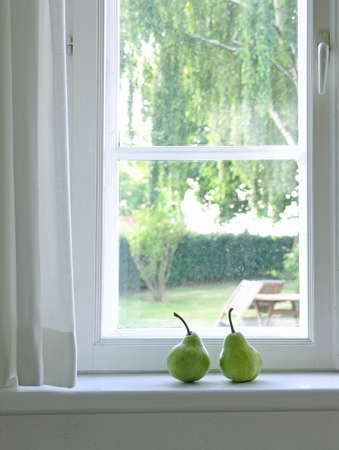 sweet, fresh, green pear on plateの写真素材