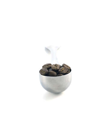 spoon full of coffee beans isolated on white backgroundの写真素材