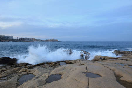 Waves crashing on a rocky shoreの写真素材