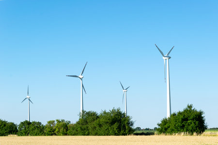 Wind power plants. Wind turbines powered by wind energy. Windmills in the fields. Environmentally...