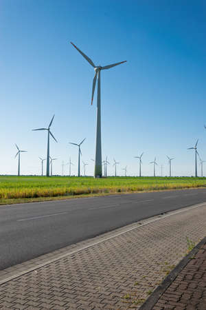 Wind power plants. Wind turbines powered by wind energy. Windmills in the fields. Environmentally...
