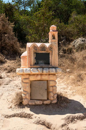 Road to the Lagoon. A small chapel by the road, with an icon inside. Religious symbol. Akamas Peninsula, Cyprus.の写真素材