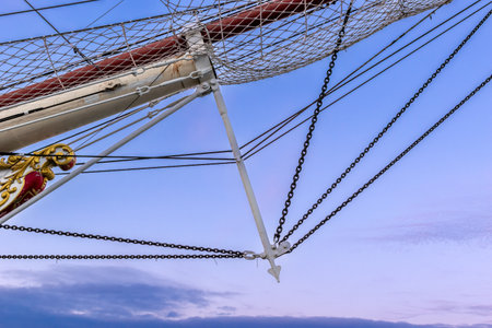 Sail. Ropes and sail attachments with safety net. A sail against the blue sky.