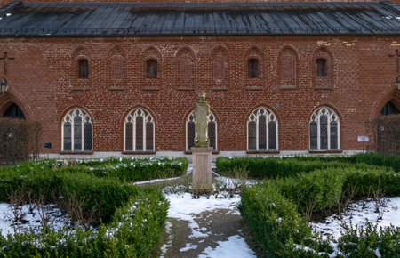 Historic pedestal in the courtyard. The statue in the crown. post-monastery complex. Kartuzy, Poland.の写真素材