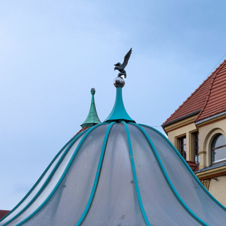 The dome of the gazebo against the blue sky. The silhouette of a bird in flight.の写真素材