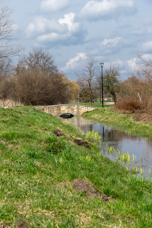 city park. A small canal that runs through the park. Bridge on the water.の写真素材