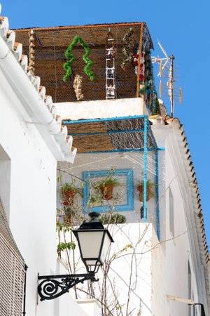Christmas and New Year decorations on Spanish houses. Colorful dwarves. White architecture in Spain.の写真素材