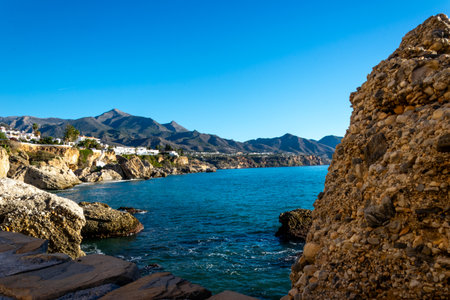 Title: View of the beautiful city of Nerja. Andalusia, Spain. Panorama of the sea, city and mountains.の写真素材