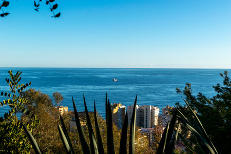 View of the sea and city in Andalusia, Spain. In the distance, a ship at sea.の写真素材