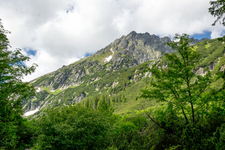 Beautiful mountain landscape in summer. Clouds surrounding the mountains. High Tatras, Poland.の写真素材